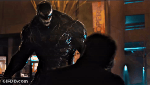 Venom Statue In Front Of Hot Sign GIF