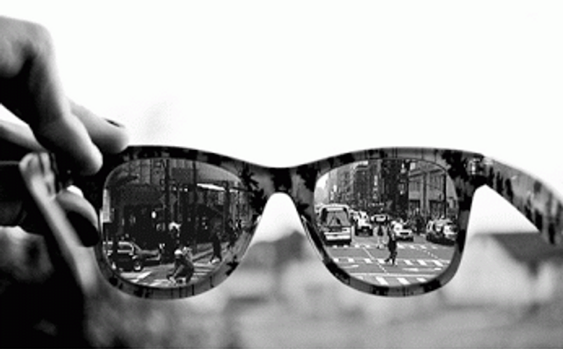 Vibrant City Life Reflected In Sunglasses GIF