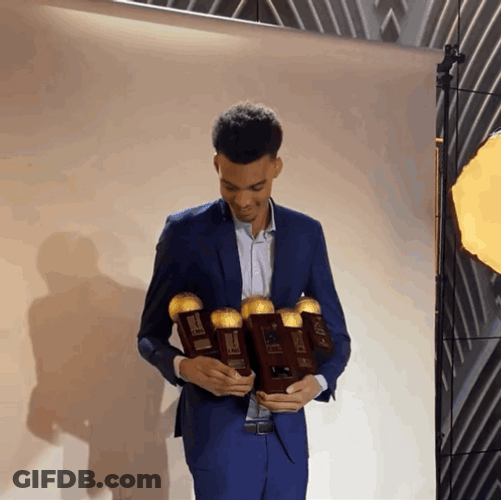 Victor Wembanyama Holding Several Trophies GIF