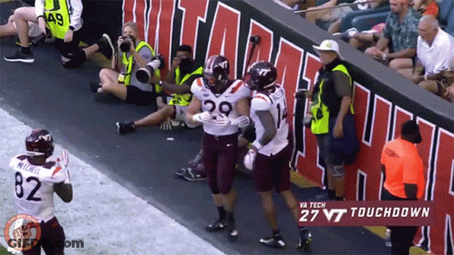 Virginia Tech Football Player Hugged By Two Teammates GIF