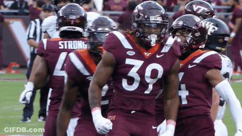 Virginia Tech Football Players Standing On Field GIF