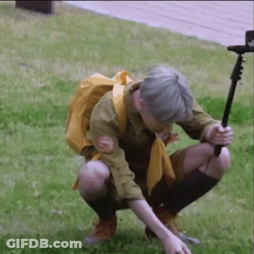 Vlogger Man Picking Grass GIF