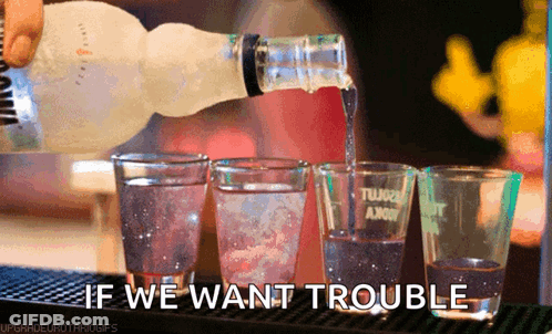 Vodka Bottle Pouring Into Shot Glasses GIF