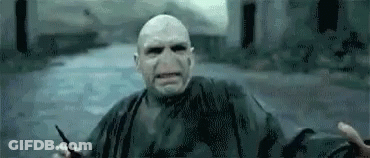 Voldemort From Harry Potter Is Holding A Wand In His Hand And Looking At The Camera . GIF