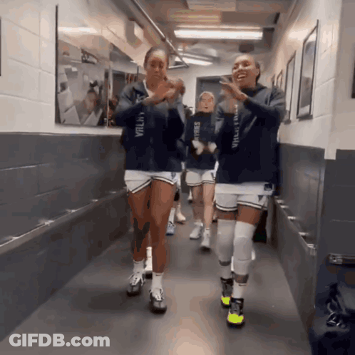 Volleyball Players Walking Down Hallway One Wearing Valley Hoodie GIF