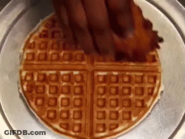 Waffle With Bacon Being Spread On Plate GIF