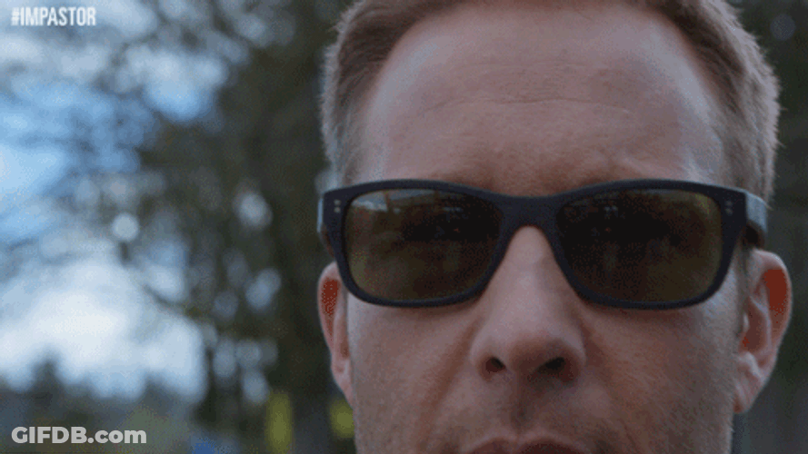 Walking Guy Taking Off His Shades GIF