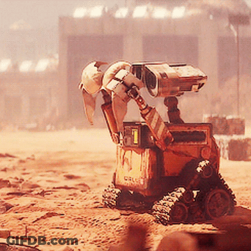 Wall E From The Movie Wall E Is Sitting In The Dirt GIF