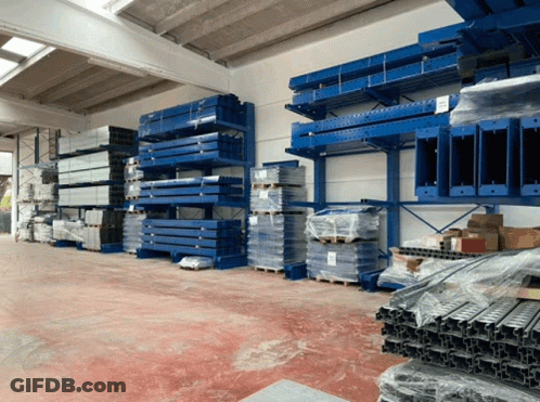 Warehouse Filled With Blue Shelves And Pallets GIF