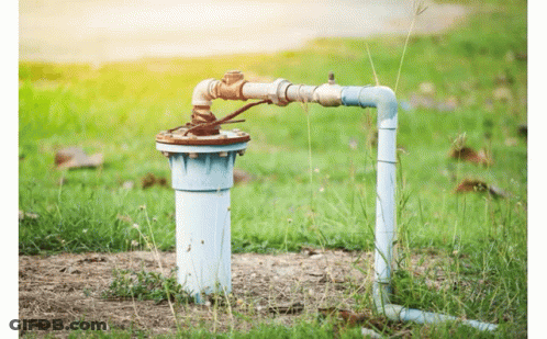 Water Pump Sitting In Grass Next To Hose GIF