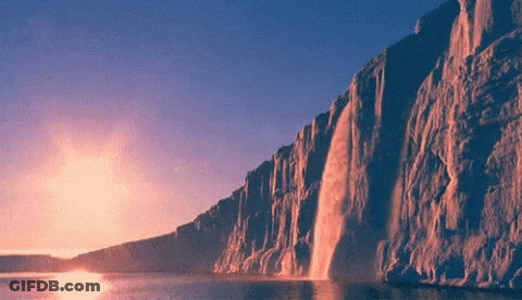 Waterfall Cliff Into Lake At Sunset GIF
