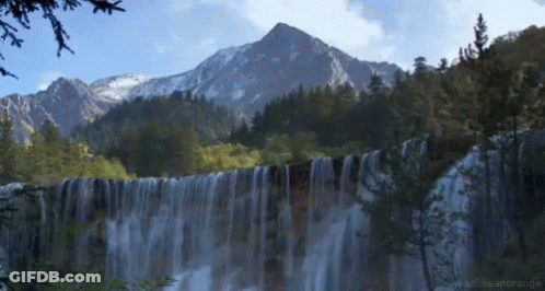 Waterfall In Forest With Mountain And Readthearange GIF