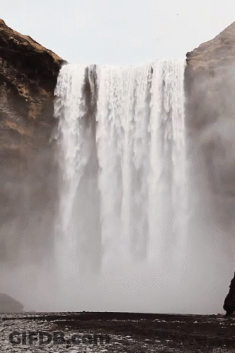 Waterfall Surrounded By Rocks And Cliff GIF
