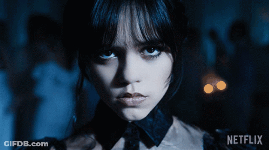 Wednesday Piercing Eyes Twisted Arms Dancing GIF