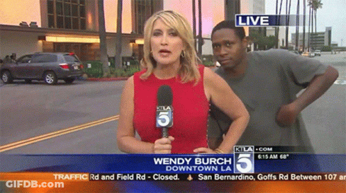Wendy Burch Reporting Downtown LA Man Looks On GIF
