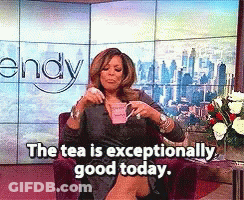 Wendy Williams Is Sitting In A Chair Drinking A Cup Of Tea GIF