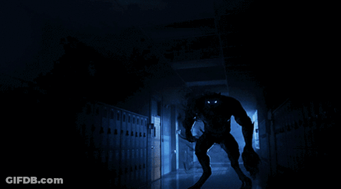 Werewolf Standing In Dark Hallway With Lockers GIF