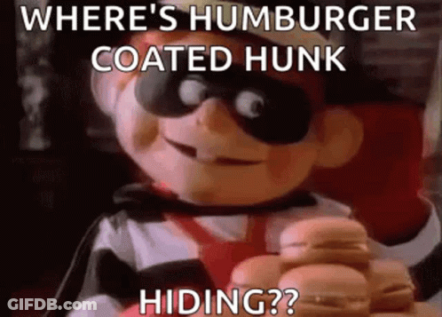Where 'S Hamburger Coated Hunk Hiding ? A Cartoon Character Is Holding A Hamburger In His Hands . GIF