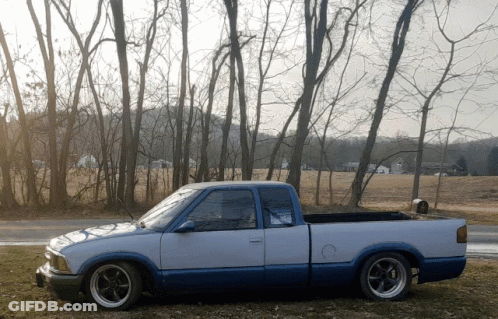 White And Blue Truck Parked In Field GIF