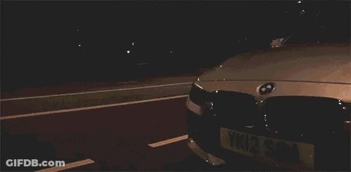 White BMW Parked In Dark Parking Lot GIF