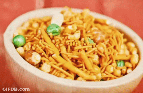 White Bowl Filled With Nuts And Noodles GIF