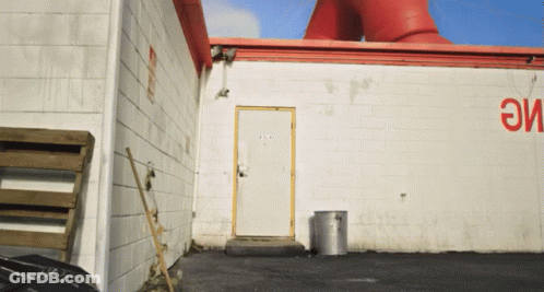 White Building With Red Sign Saying Eme GIF