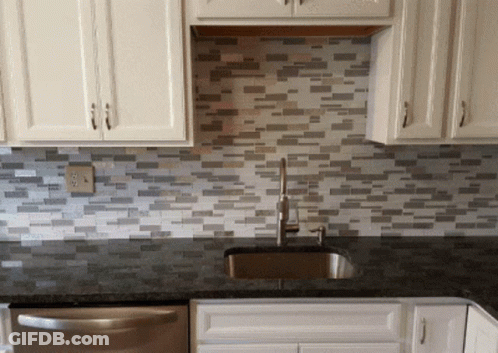 White Cabinets Kitchen With Black Countertop GIF