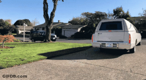 White Cadillac Parked In Driveway With California License Plate DF-290 GIF