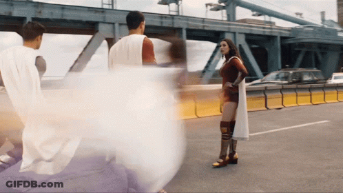 White-Caped Man And Red-Dressed Woman On Highway GIF