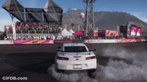 White Car Drifting In Front Of Crowd At Motorsport Festival GIF