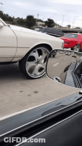 White Car Driving Down Highway With Red Car GIF
