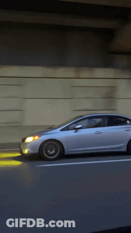White Car Driving On Highway With Headlights On GIF