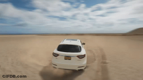 White Car Driving Through Desert GIF