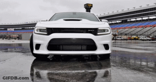 White Car Parked In Wet Parking Lot GIF
