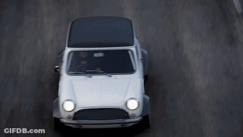 White Car With Black Top Driving Down Road GIF