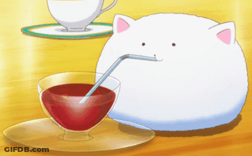 White Cat Drinking From Straw Next To Red Liquid GIF