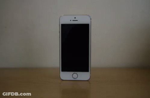 White Cell Phone On Wooden Table GIF