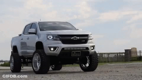 White Chevrolet Colorado Pickup Truck In Gravel Lot GIF