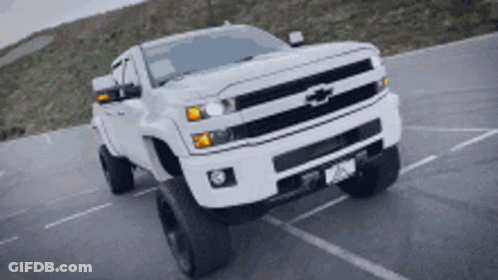 White Chevrolet Truck Driving Down Road GIF