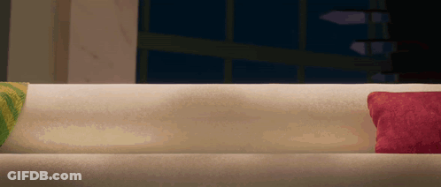 White Couch With Two Pillows In Dark Room GIF