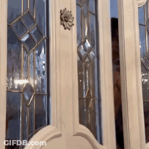 White Door With Stained Glass And Flower GIF