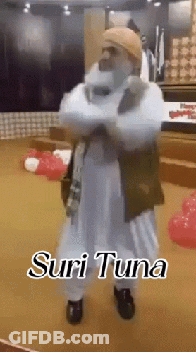 White Dress Man With Hat Balloons Suri Tuna Sign GIF