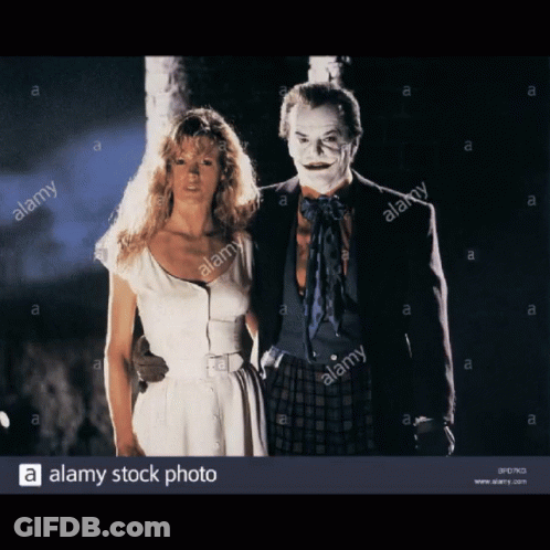 White Dress Woman Next To Joker Costume Man GIF