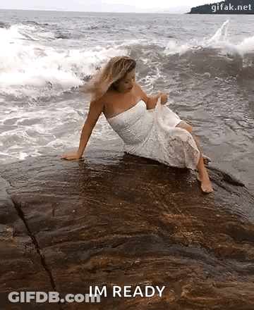 White-Dressed Woman On Ocean Rock Saying Im Ready GIF