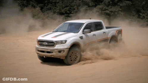 White Ford Truck Driving Through Sandy Area GIF
