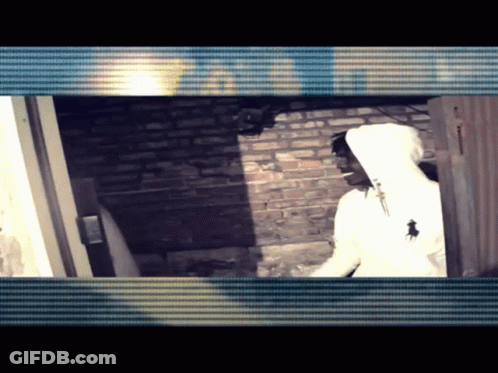 White Hoodie Man By Brick Wall And Door GIF