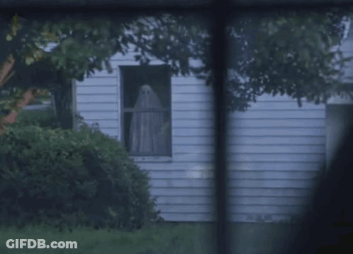 White House With Ghost Looking Out Window GIF
