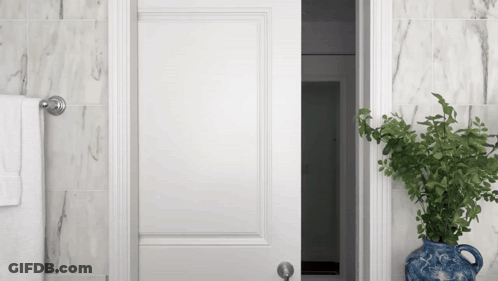 White Open Door To Marble Bathroom GIF
