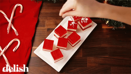 White Plate With Red Squares Saying Delish GIF