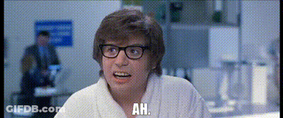 White Robot Laying On Table With Pillow GIF